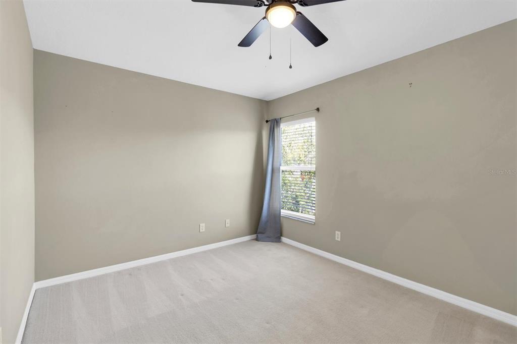 10121 Porch Street New Port Richey, FL 34655 - Photo 31 of 57 an empty room with windows and chandelier fan