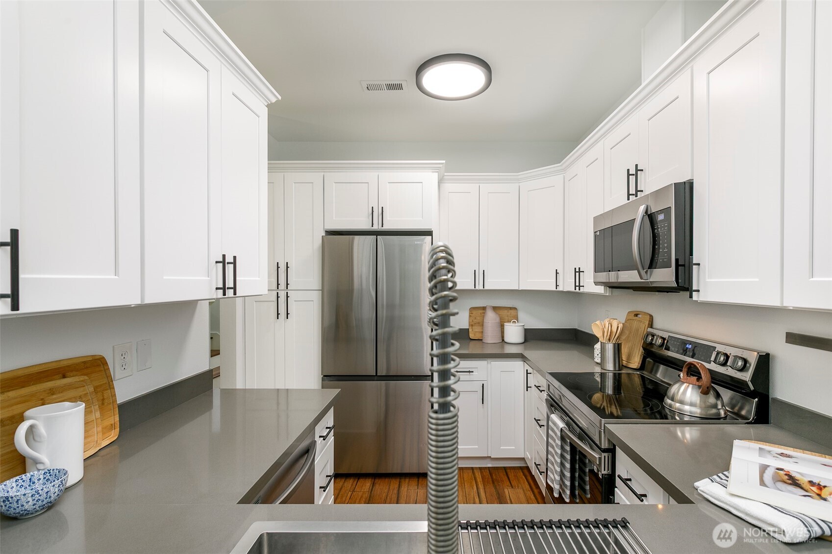 8828 238th Street Southwest, Unit C3 Edmonds, WA 98026 - Photo 12 of 29 a kitchen with stainless steel appliances a refrigerator a sink a stove top oven a counter space and cabinets