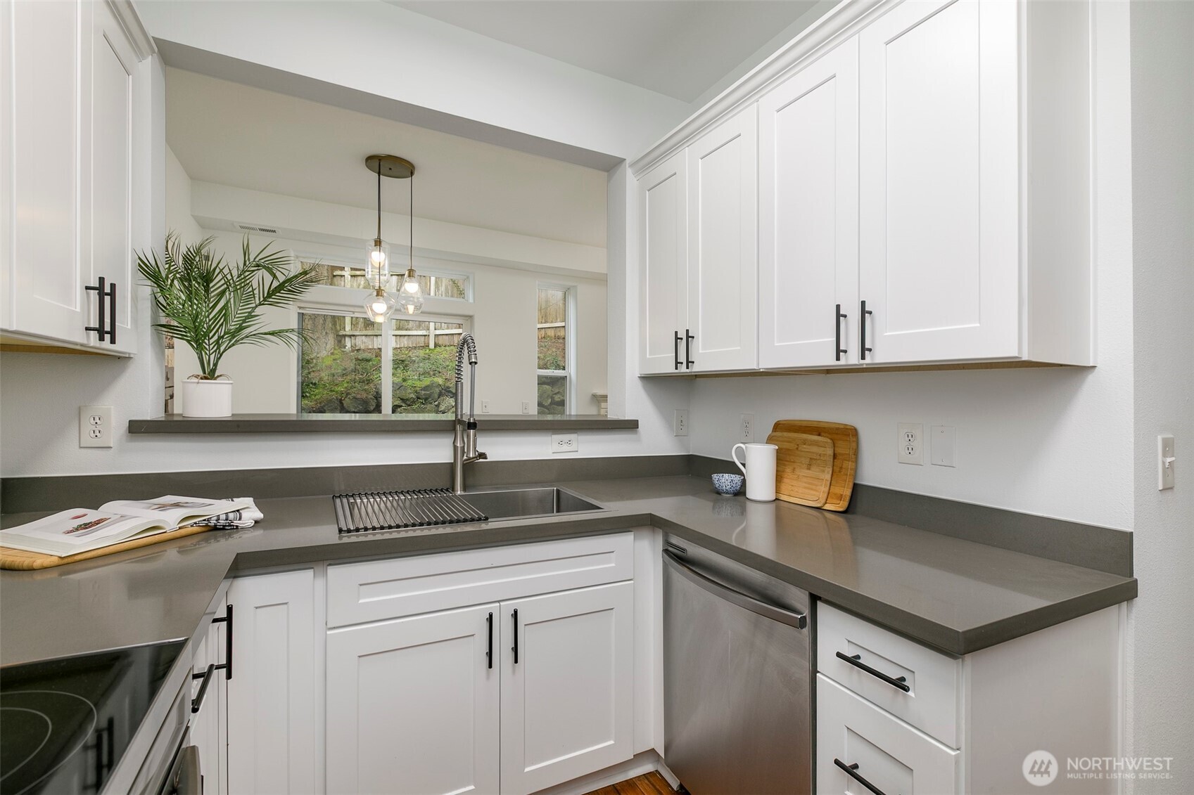 8828 238th Street Southwest, Unit C3 Edmonds, WA 98026 - Photo 14 of 29 a kitchen with stainless steel appliances granite countertop a sink stove and cabinets