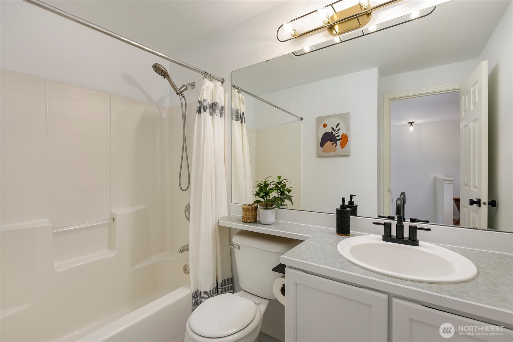 8828 238th Street Southwest, Unit C3 Edmonds, WA 98026 - Photo 21 of 29 a bathroom with a sink a toilet a mirror and shower