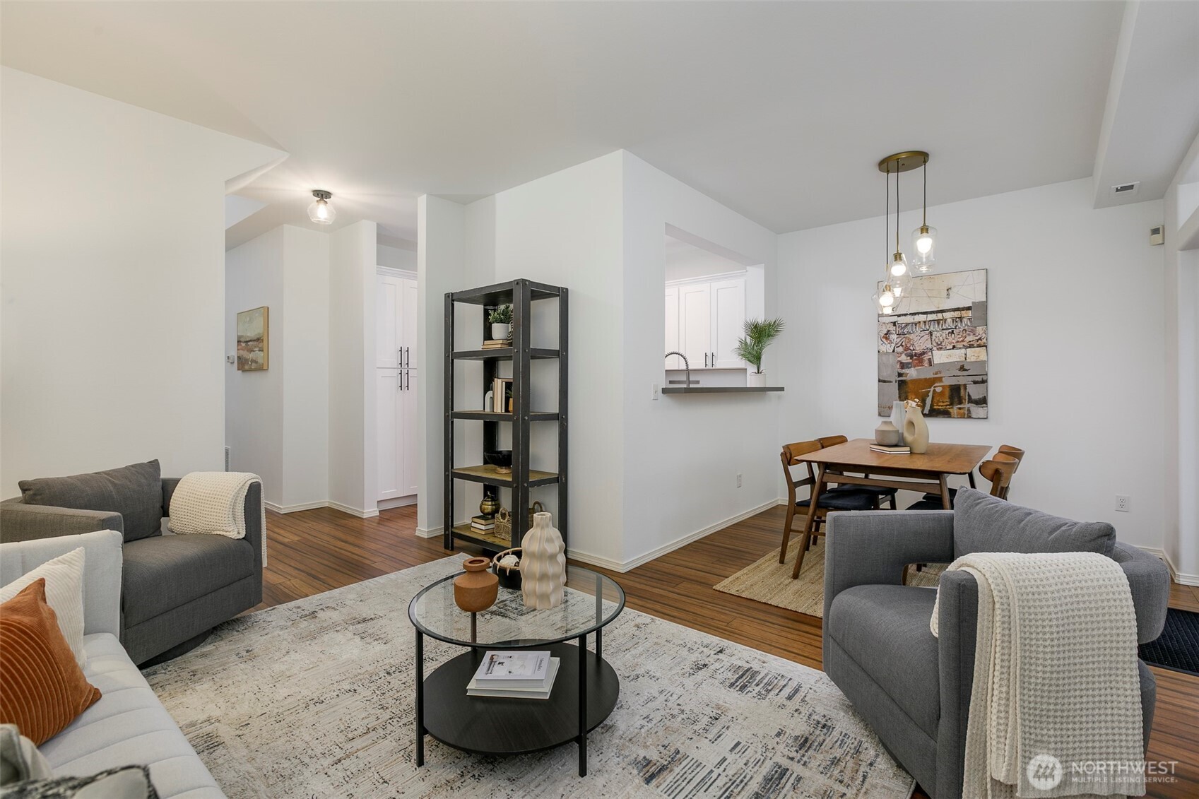 8828 238th Street Southwest, Unit C3 Edmonds, WA 98026 - Photo 8 of 29 a living room with furniture a rug and a chandelier