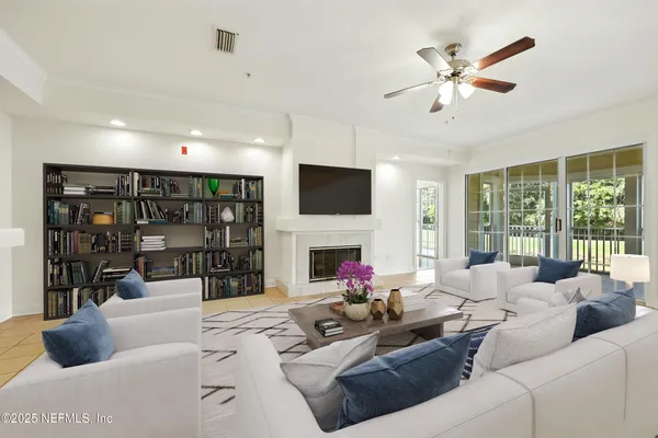 a living room with fireplace furniture and a large window