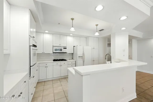 a kitchen with stainless steel appliances kitchen island granite countertop a sink and cabinets