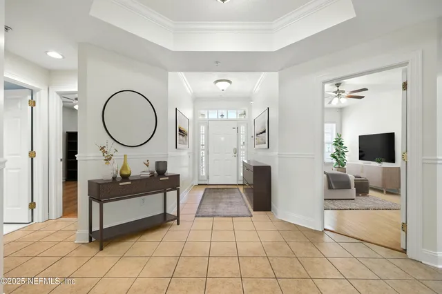 a view of an empty room with a floor to ceiling window and a living room