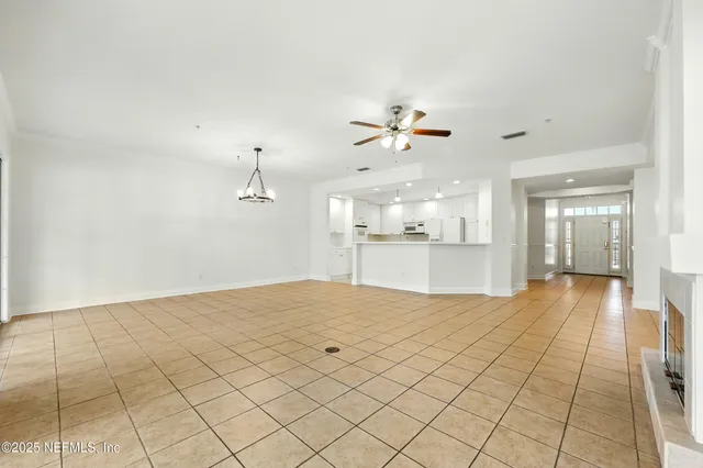 a large white kitchen with a sink and cabinets