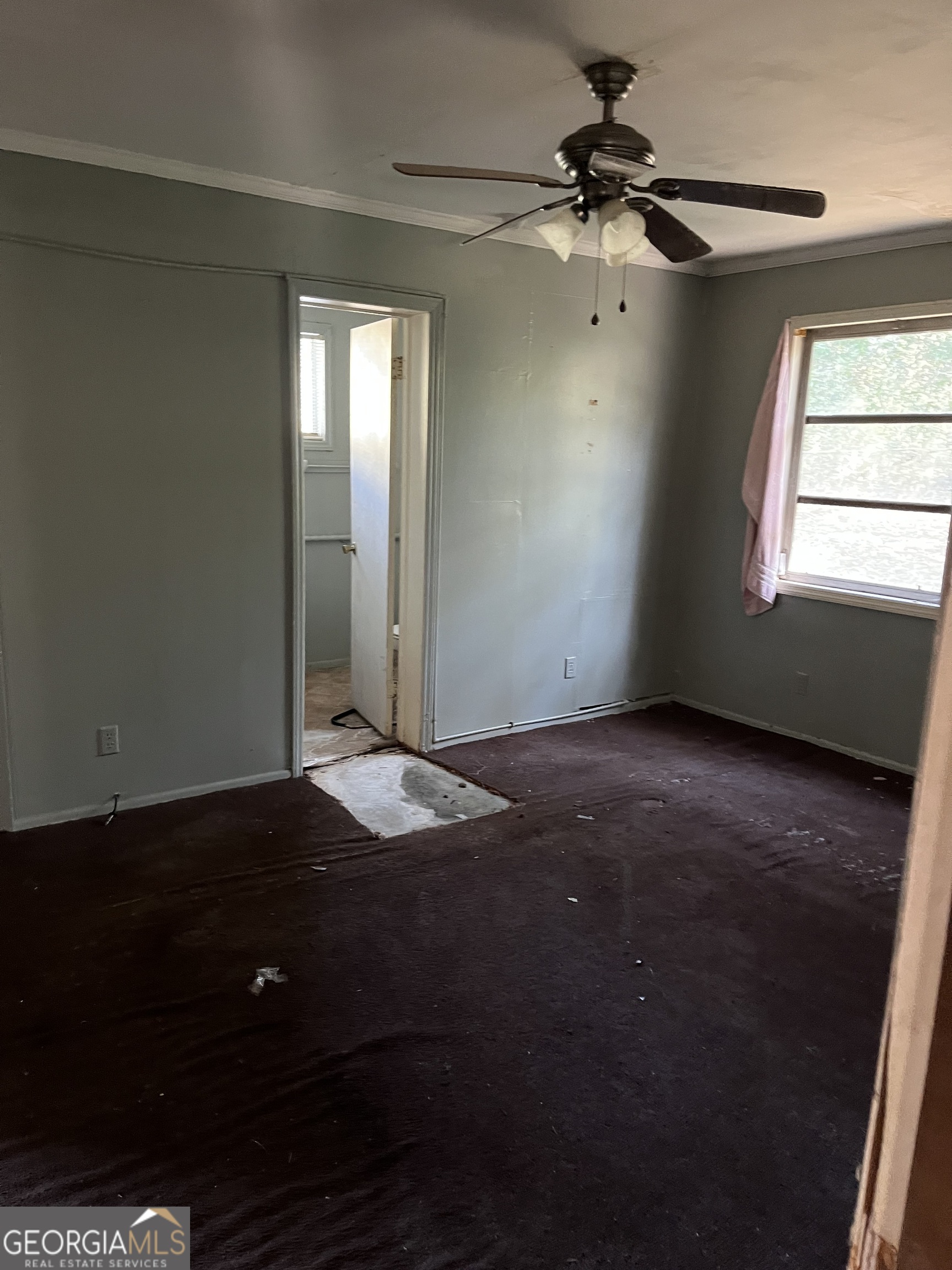 3450 Travis Boulevard Macon, GA 31206 - Photo 7 of 7 an empty room with windows and fan