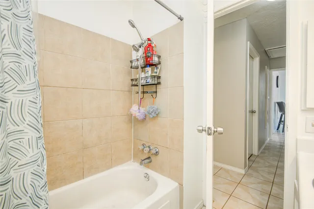 a bathroom with a bathtub and shower