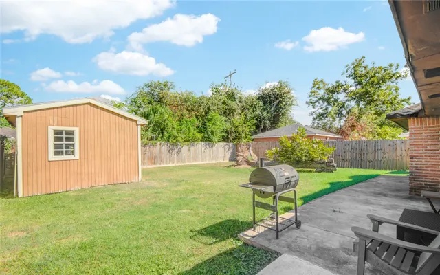 a backyard of a house with table and chairs