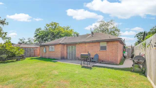 a backyard of a house with table and chairs