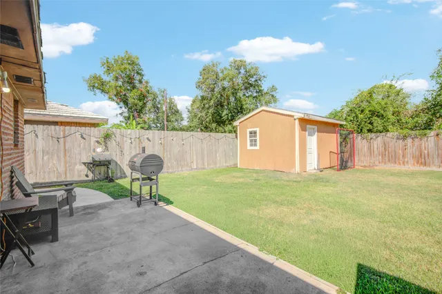 a view of backyard with outdoor seating and green space