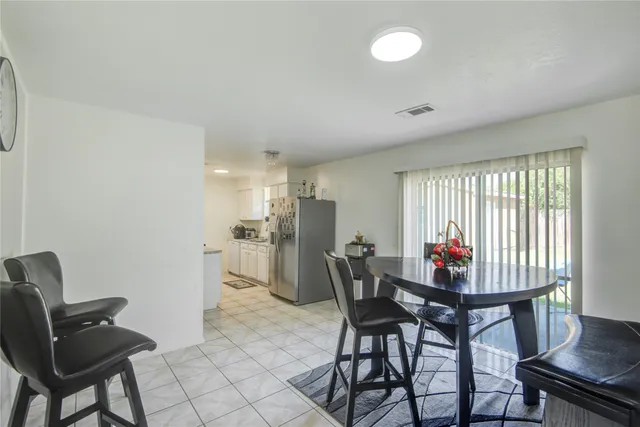 a view of a dining room with furniture and a window