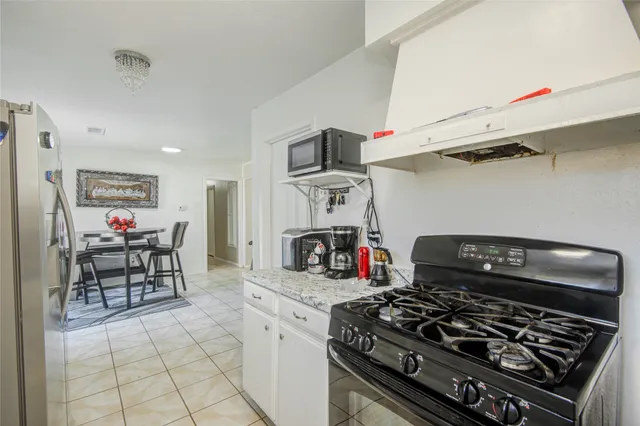 a kitchen with a stove and a table