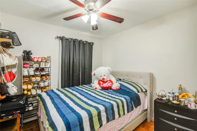 a bedroom with bed and a chandelier