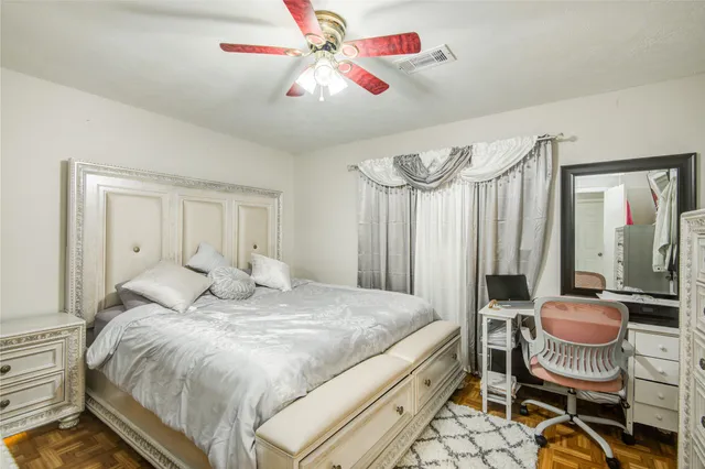 a bedroom with a bed and a chandelier