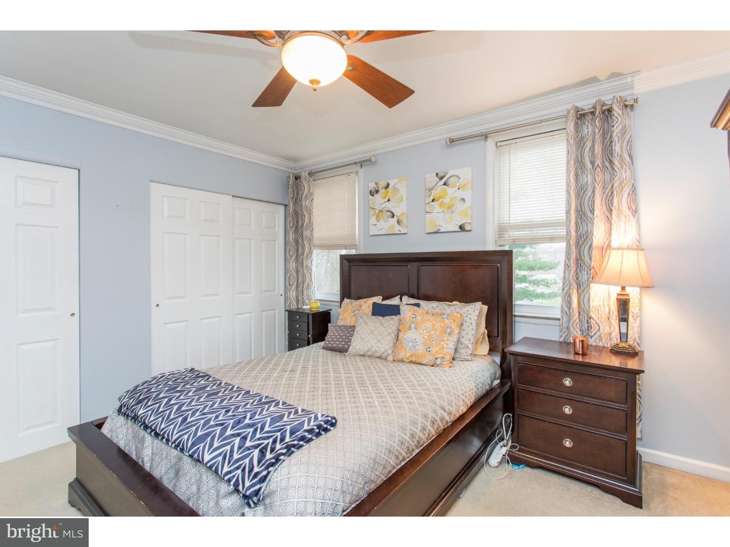 11902 Stevens Road Philadelphia, PA 19116 - Photo 12 of 21 a bedroom with a bed and a chandelier