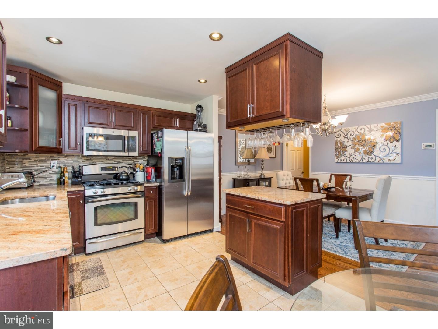 11902 Stevens Road Philadelphia, PA 19116 - Photo 6 of 21 a kitchen with stainless steel appliances granite countertop a stove refrigerator and a microwave