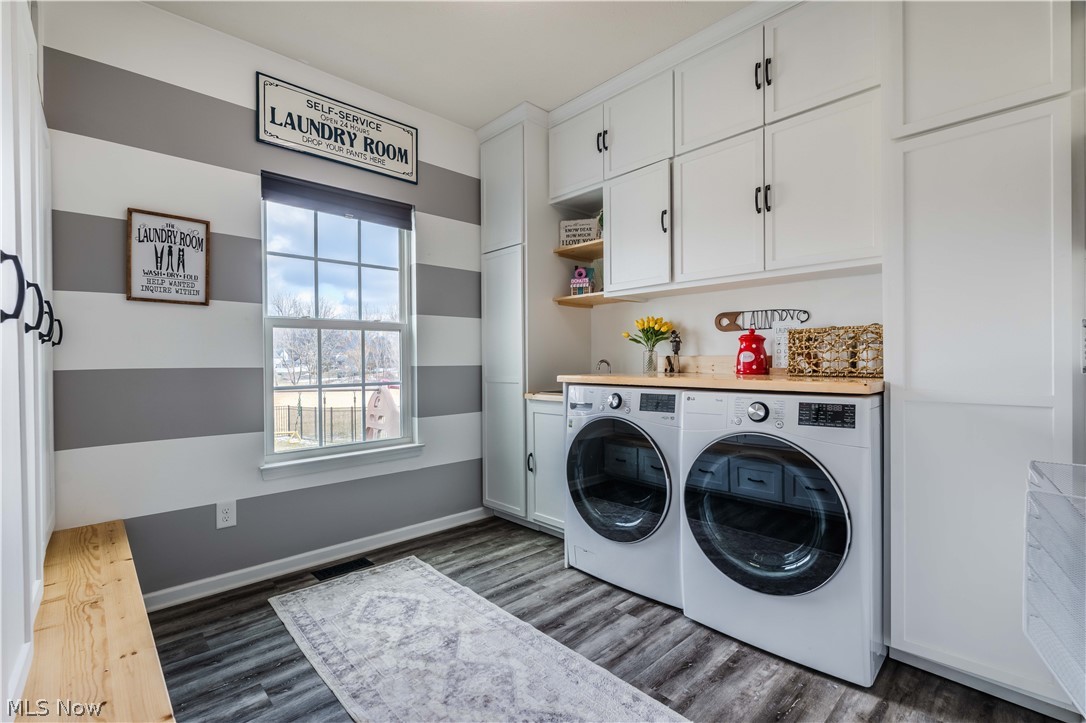 6687 List Street Northwest Canton, OH 44708 - Photo 11 of 21 Laundry area with cabinet space, dark wood-style floors, and separate washer and dryer