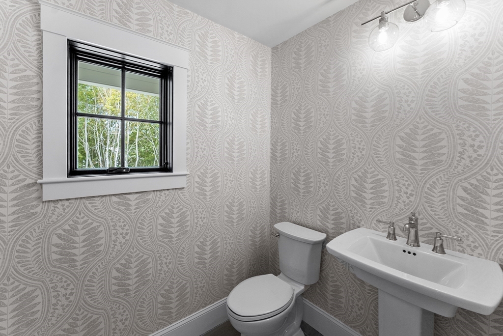 46 Sandwich Road, Unit 26 Plymouth, MA 02360 - Photo 28 of 41 a bathroom with a sink a toilet and a window