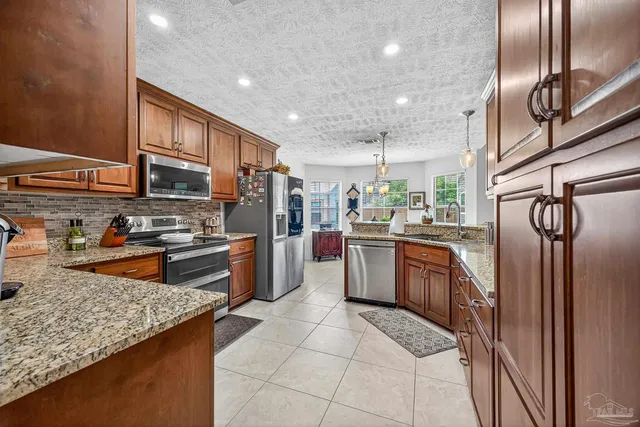a dining room filled chandelier and wooden floor