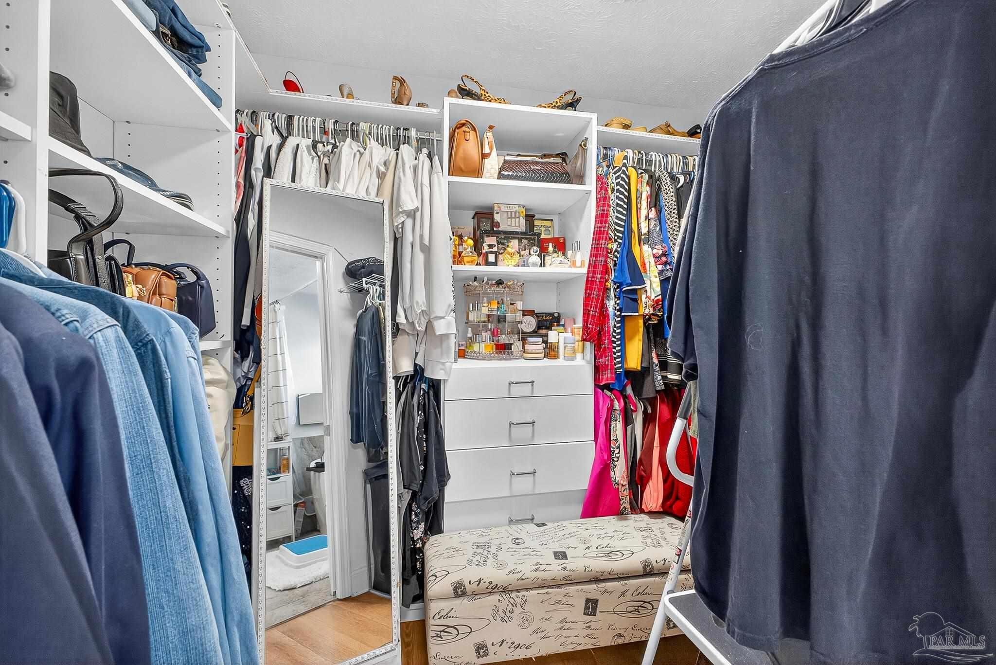 10051 Bristol Park Road Cantonment, FL 32533 - Photo 15 of 60 a view of walk in closet with clothes and shoes