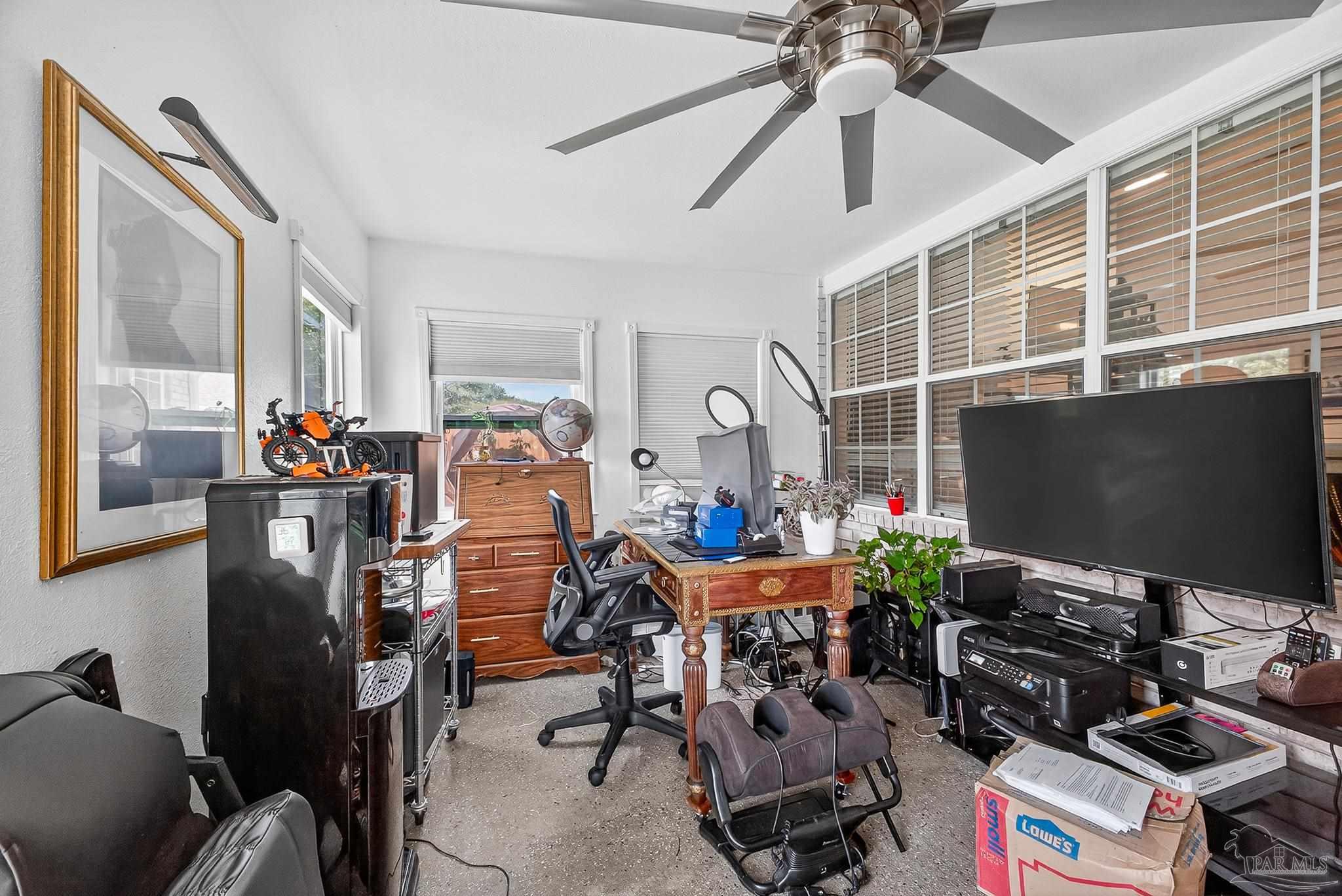 10051 Bristol Park Road Cantonment, FL 32533 - Photo 16 of 60 a room with gym equipment and a flat screen tv