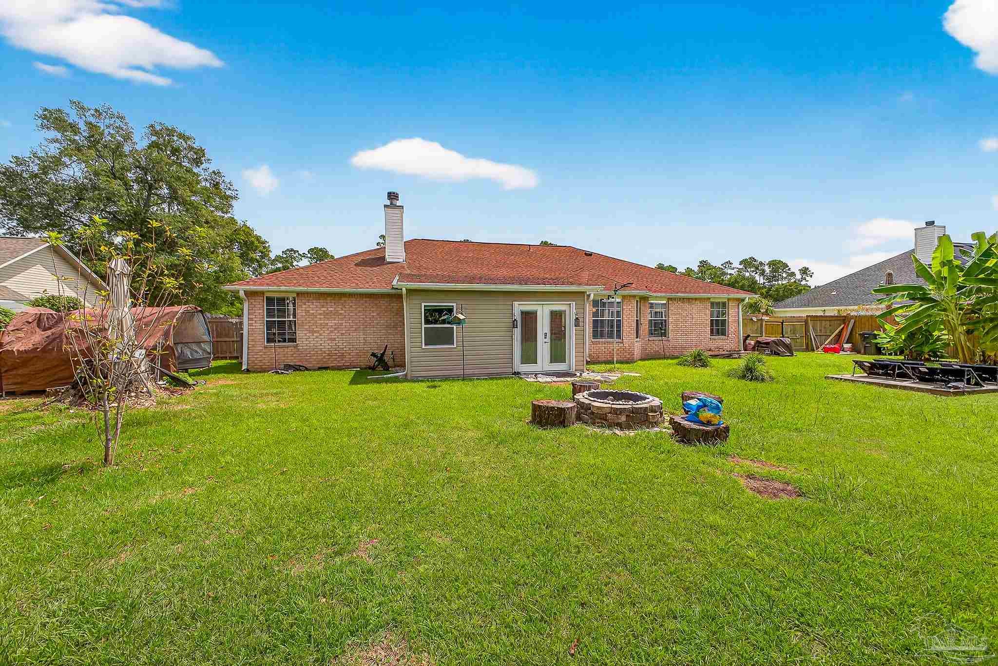 10051 Bristol Park Road Cantonment, FL 32533 - Photo 17 of 60 a front view of a house with garden