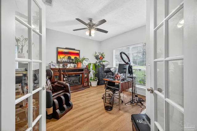 a bedroom with bed and wooden floor