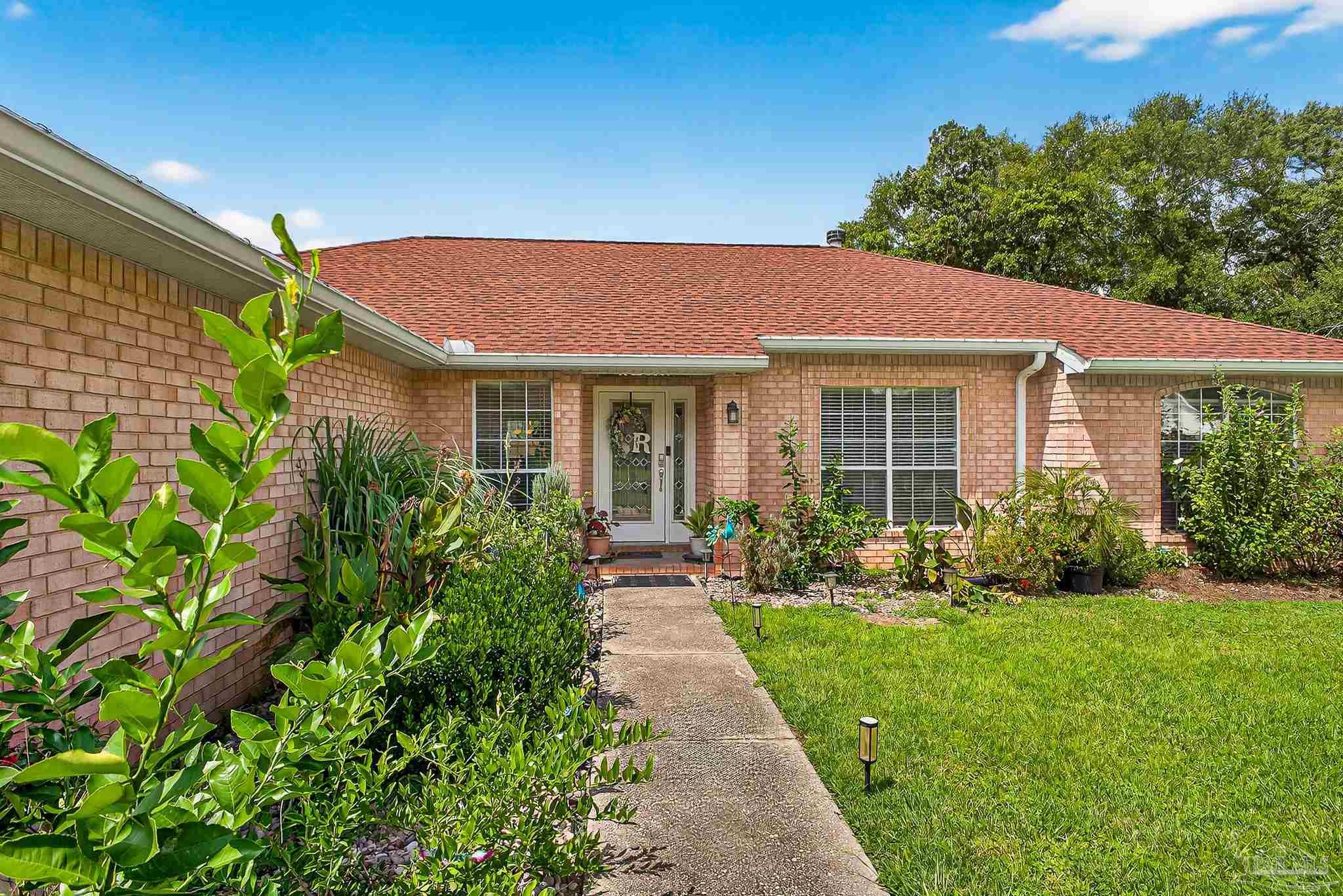 10051 Bristol Park Road Cantonment, FL 32533 - Photo 21 of 60 a front view of a house with a yard