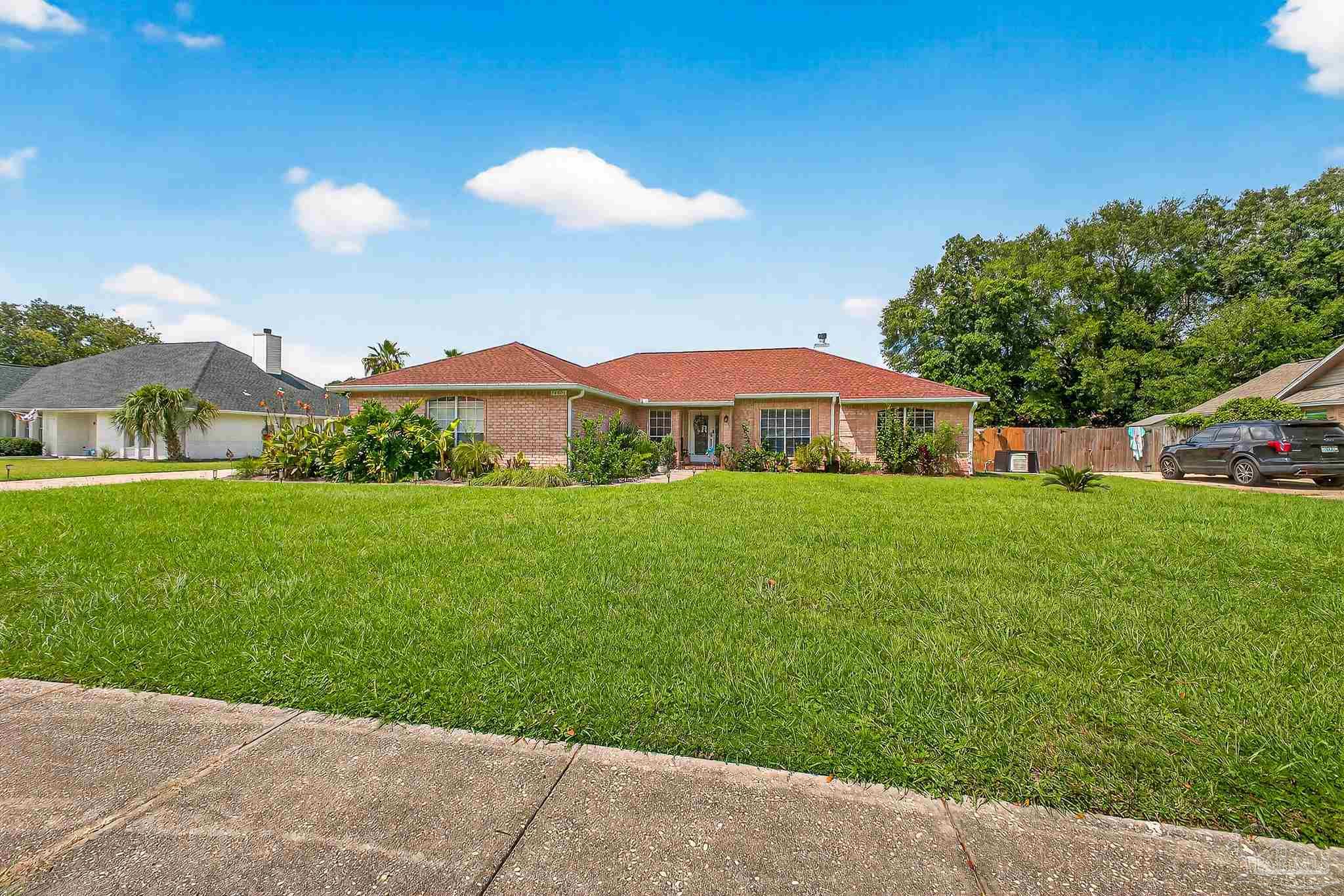 10051 Bristol Park Road Cantonment, FL 32533 - Photo 22 of 60 a front view of house with yard and green space