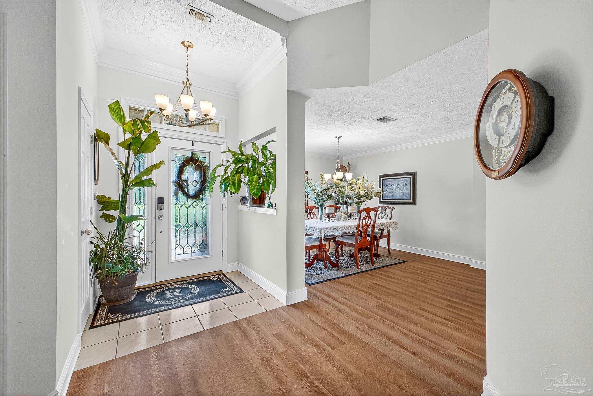 10051 Bristol Park Road Cantonment, FL 32533 - Photo 26 of 60 a view of living room filled with furniture and paintings on the wall