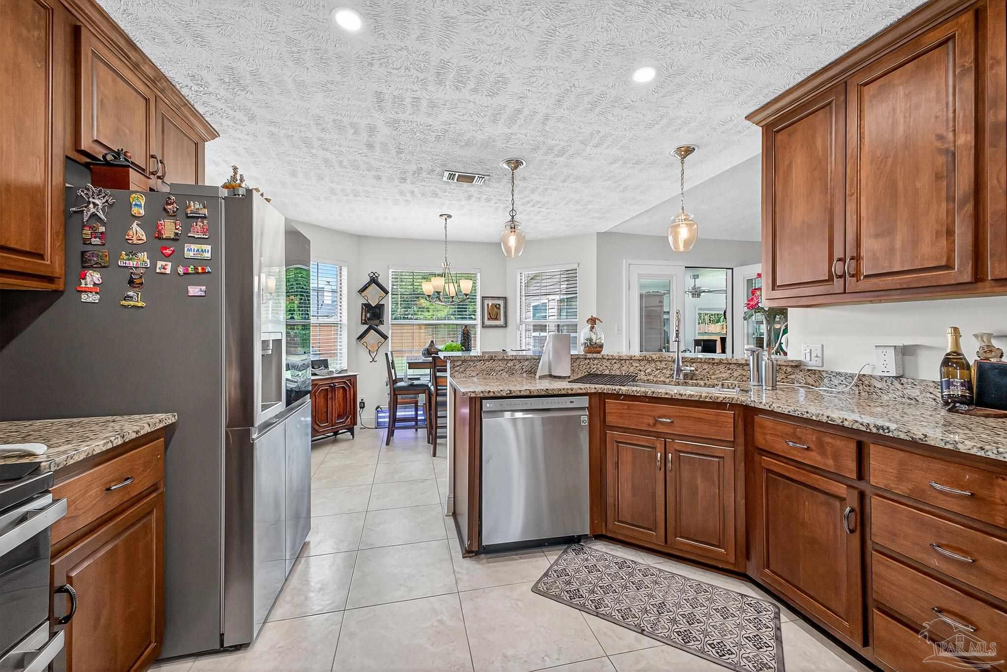 10051 Bristol Park Road Cantonment, FL 32533 - Photo 28 of 60 a kitchen with lots of counter top space and appliances