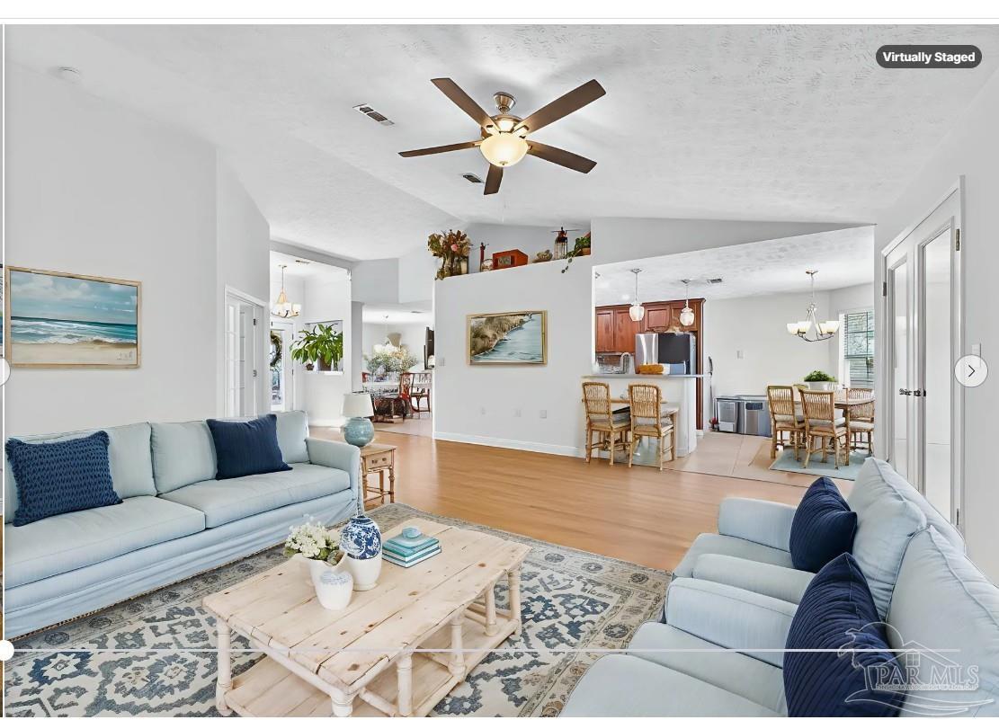 10051 Bristol Park Road Cantonment, FL 32533 - Photo 3 of 60 a living room with furniture or couch and a wooden floor