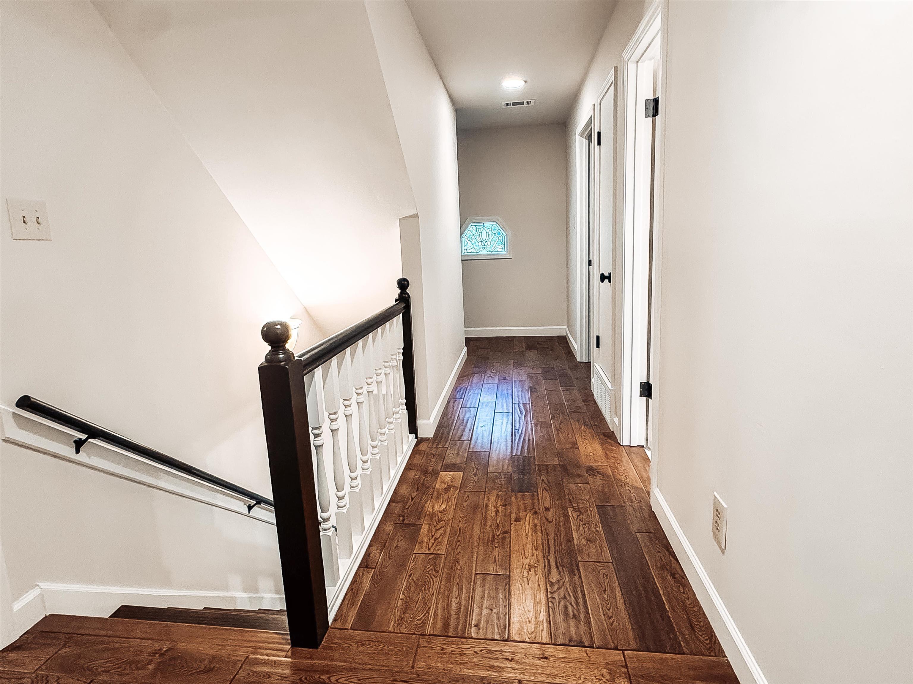 832 South Tree Drive Collierville, TN 38017 - Photo 35 of 40 Hallway with wood-finish flooring, white walls, and white trim