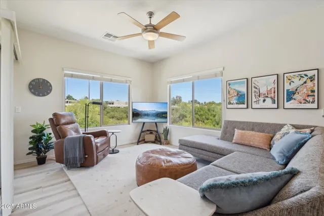 a living room with furniture and a large window
