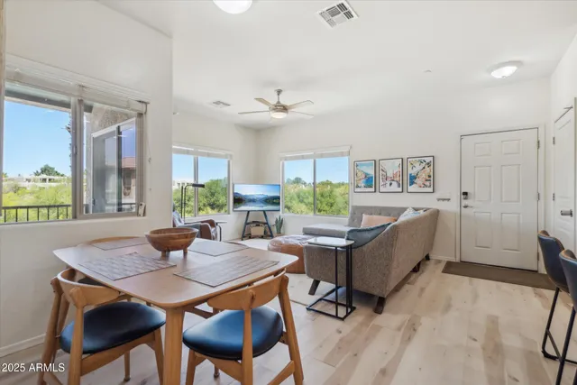 a view of a dining room with furniture and a window