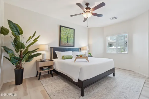 a bedroom with a bed and a potted plant