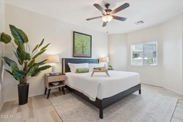 a bedroom with a bed and a potted plant