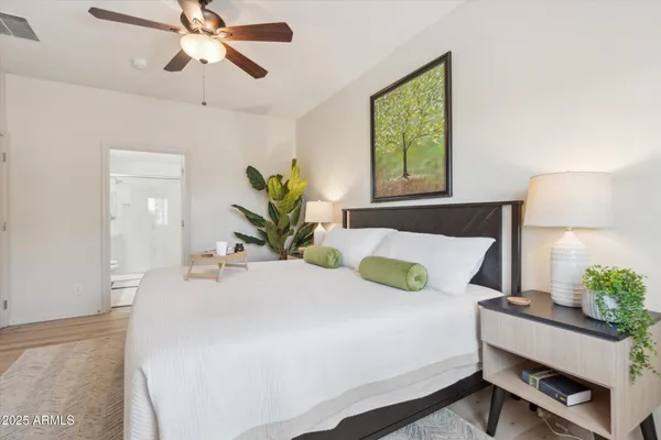 a bedroom with a bed table and window