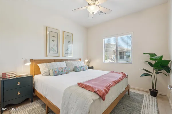 a bedroom with a bed and a chandelier