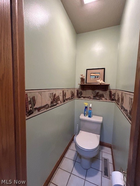 1126 Mudbrook Road Huron, OH 44839 - Photo 10 of 22 Bathroom featuring toilet, tile flooring, and a textured ceiling