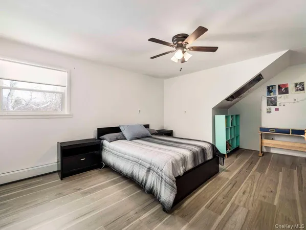 a bedroom with a bed and a ceiling fan
