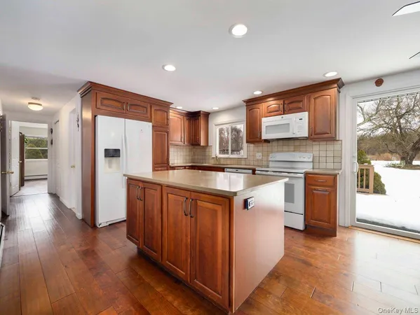a kitchen with stainless steel appliances granite countertop a refrigerator a sink and a stove