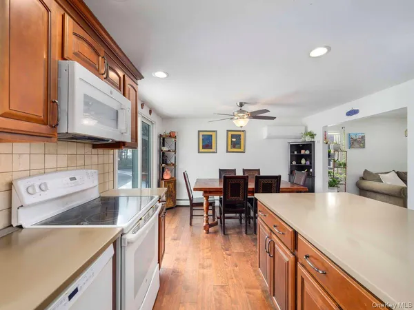 a kitchen with stainless steel appliances granite countertop a sink dishwasher stove refrigerator and cabinets