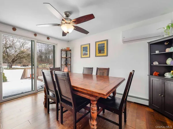 a view of a dining room with furniture window and wooden floor