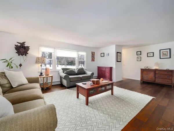 a living room with furniture and a potted plant on table