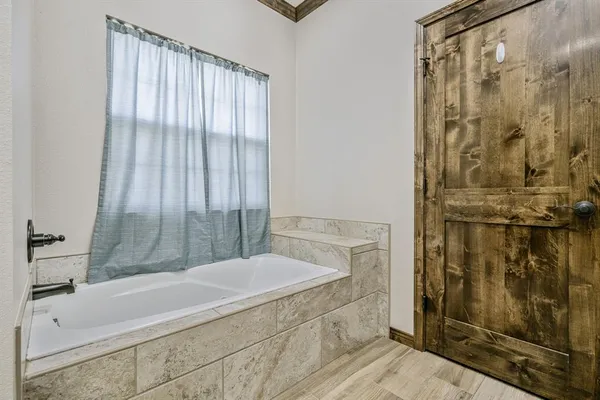 a bathroom with a bathtub and shower