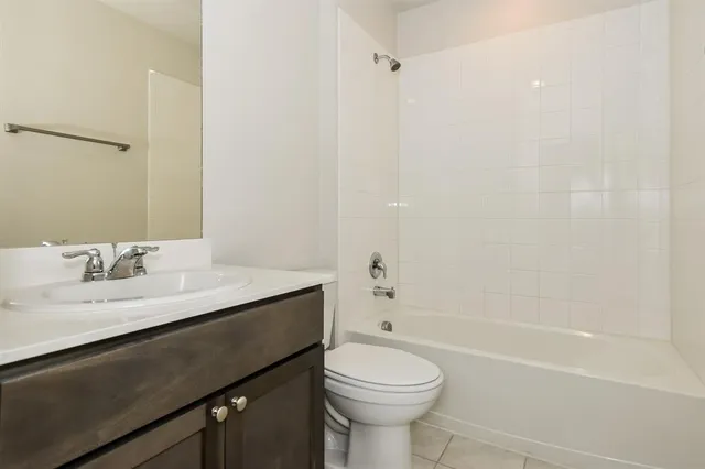 a bathroom with a granite countertop sink toilet a mirror and shower