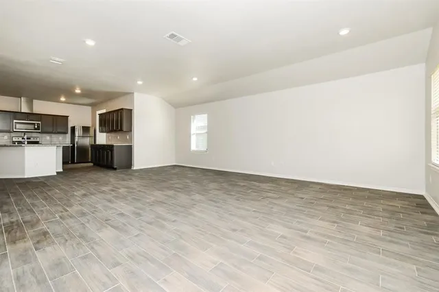 a view of a kitchen with a sink and a refrigerator