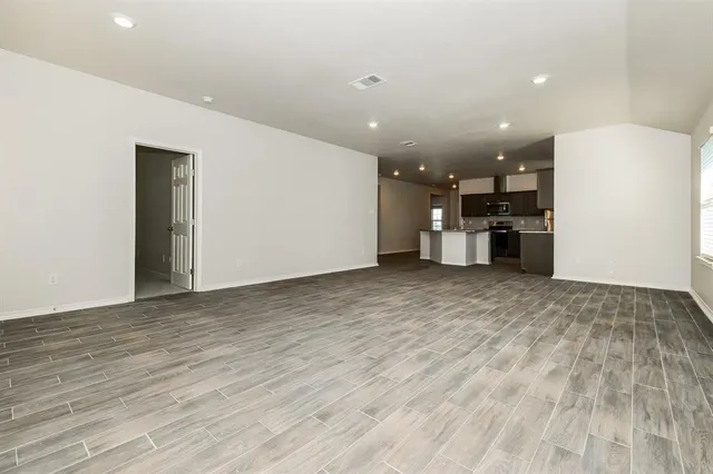 a view of a kitchen with a refrigerator and a window