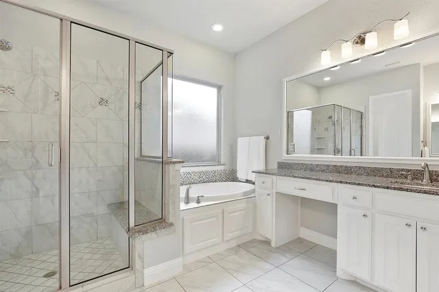 a bathroom with a granite countertop sink mirror and a shower